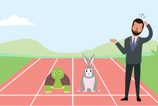 a school administrator stands next to a tortoise and a hare on the school running track